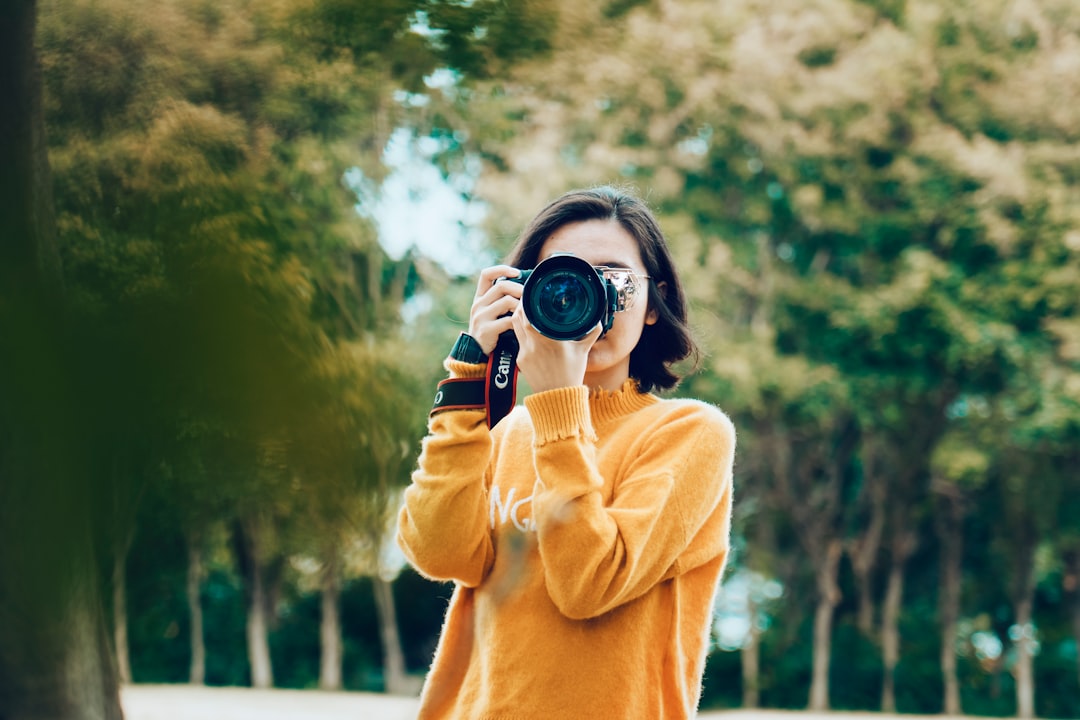 woman-holding-dslr-camera-toupbco62lw